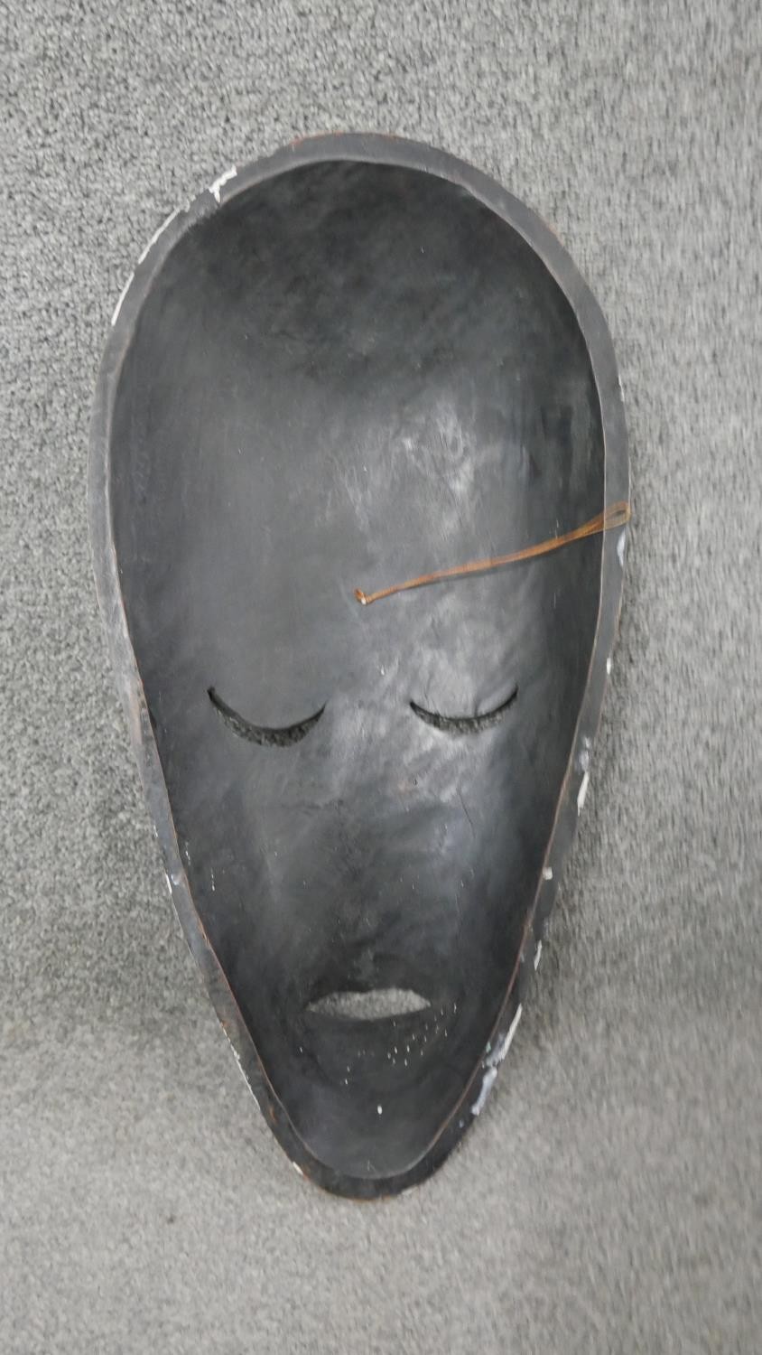 Three carved hardwood African tribal masks. H.44 W.25cm (largest) - Image 3 of 7