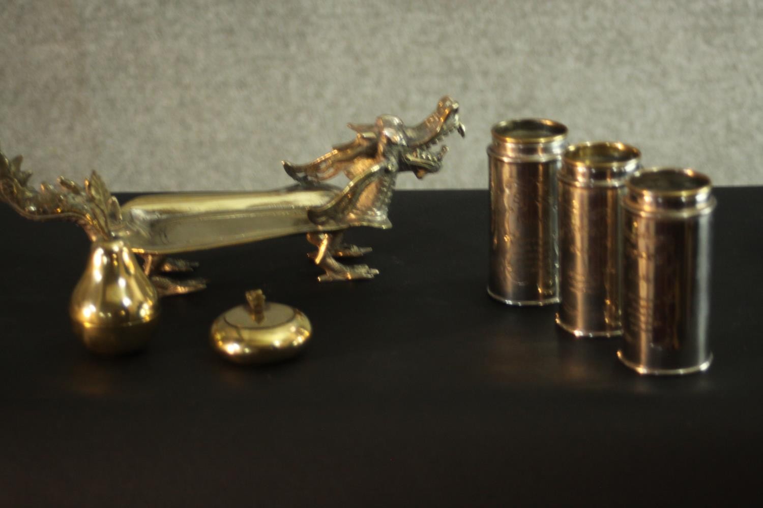 A silver plated Chinese dragon card tray, three lidded spice cannisters and other silver plate. H.10
