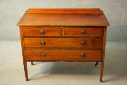 An Edwardian mahogany and inlaid chest of drawers on square tapering supports. H.86 W.106 D.48 cm.