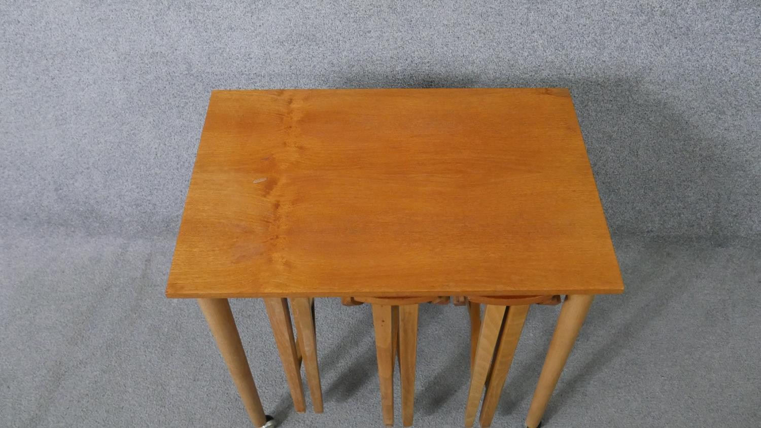 A vintage light teak nest of tables on beech supports fitted with three slide out drop flap - Image 2 of 8