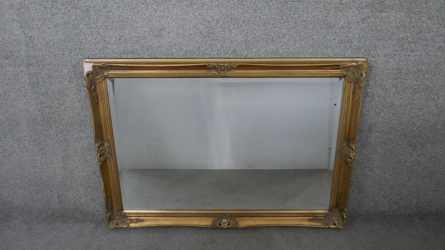 A gilt framed wall mirror with rectangular bevelled plate. H.75 W.105cm