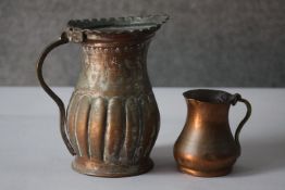 Two copper jugs. One with a gadrooned design. H.17 W.11 D.18 cm.