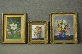 A gilt framed oil on canvas, flowers in a vase along with two similar examples. H.68 W.55cm.