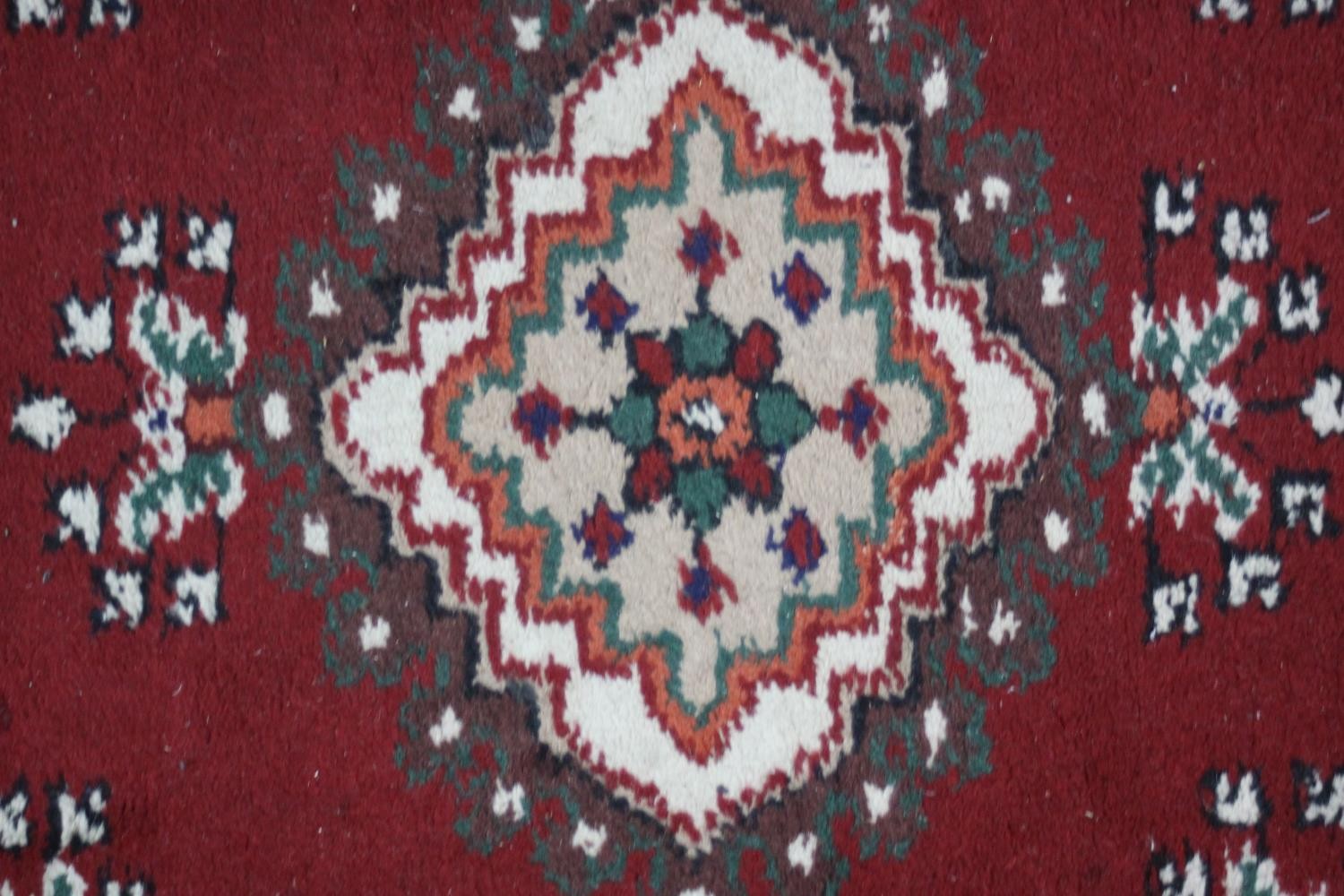 Two small Eastern rugs each on a red ground. L.110 W.60cm. (largest) - Image 6 of 8