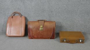Three vintage tan leather bags. One tan leather doctors bag with brass fittings and two other pieces