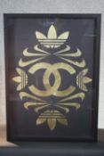 A framed and glazed print on cloth, a composition from the Adidas, Nike and Chanel logos. H.73 W.