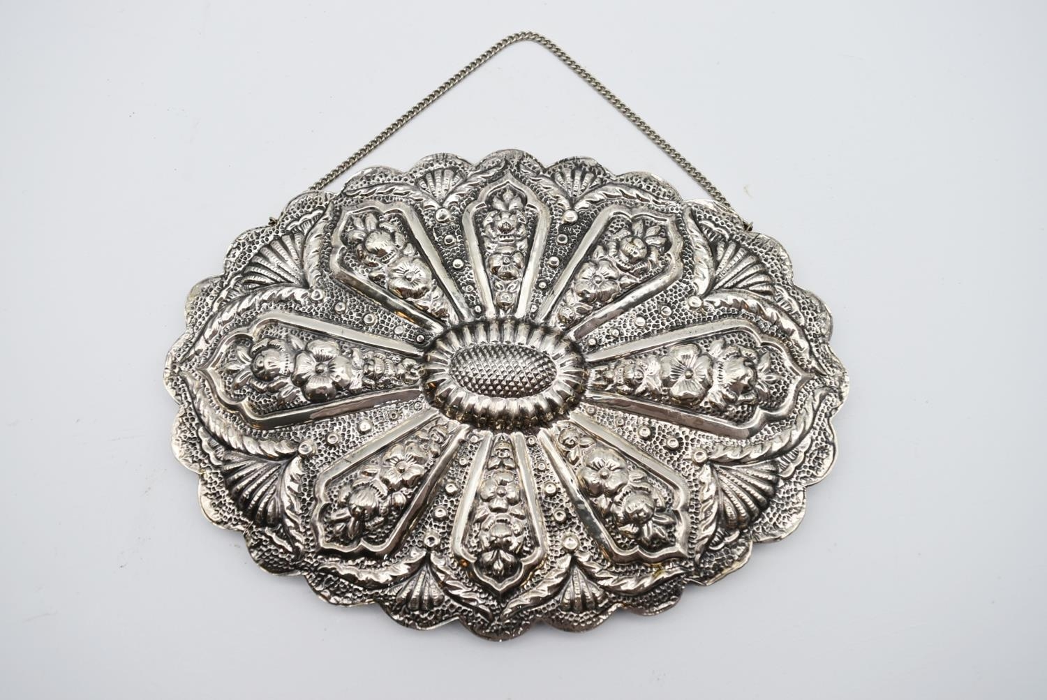 A 20th century Indian silver repousse mirror with stylised foliate and floral design and hanging - Image 4 of 8
