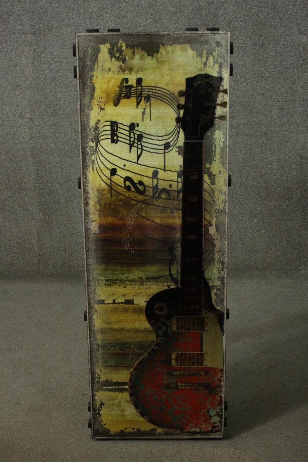A large mixed media artwork on panel of a Gibson guitar among music notes, with studded detailing