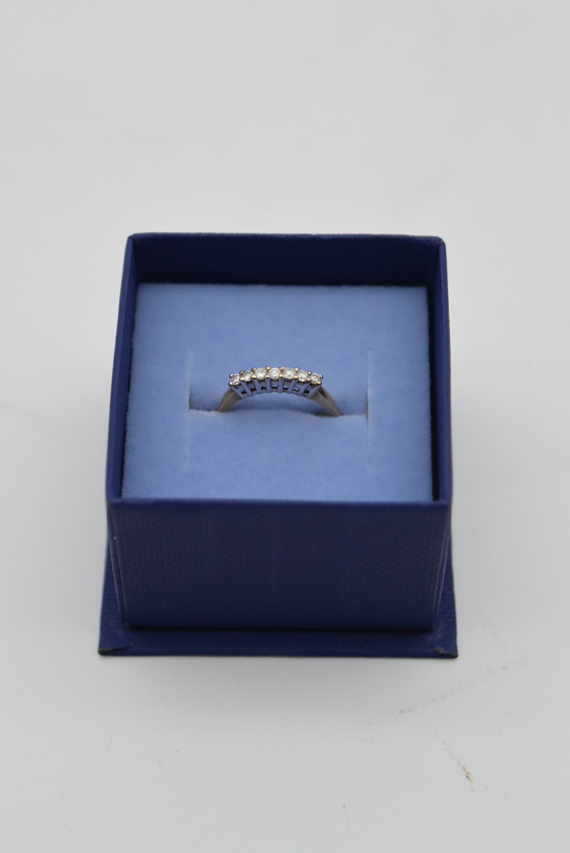 A seven stone diamond and 18 carat gold ring. Set with seven round brilliant cut diamonds in open - Image 2 of 7