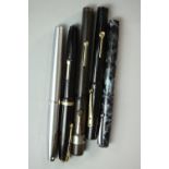 A collection of five 14 carat gold-nibbed fountain pens, including a Sheaffer brushed chrome