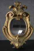 A 19th century carved giltwood wall mirror with scrolling foliate cresting. H.59 W.40cm.