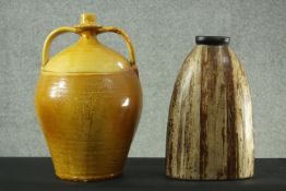 A large glazed twin handled stoneware flagon and a painted hardwood vase. H.42 Dia.25 cm.