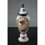 A large pale pink Victorian milk glass lidded jar, decorated with a portrait of a young woman within