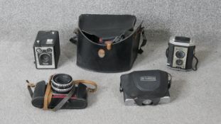 A collection of vintage cameras. Including a Yashika, Praktika super TFL and two vintage brownie