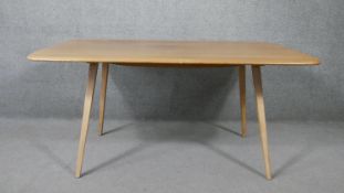 A vintage Ercol model 382 dining table with blonde elm top on beech supports. H.70 W.151 D.103cm