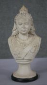 An antique reconstituted marble bust of Queen Victoria on a round ebonised base. H.36 W.18 D.13cm