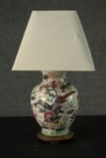 A 20th century Oriental vase converted to a table lamp mounted on a hardwood base. Decorated with