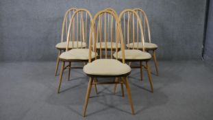 A set of six vintage Ercol Quaker dining chairs with elm seats and beech splat backs and supports.