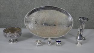 A collection of silver plate including a three piece cruet set with blue glass liner, a flower frog,