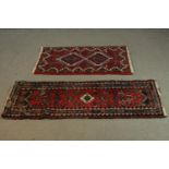 A small Persian rug on burgundy ground and a similar rug. L.143 W.49cm.