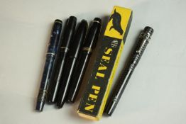 A collection of five 14 carat gold-nibbed fountain pens, including a boxed engine decorated black