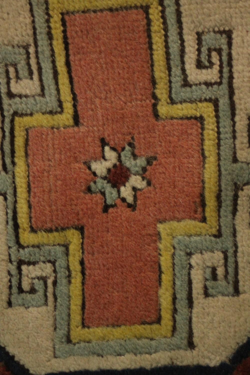A Turkish runner with repeating lozenge medallions within a flowerhead border. L.310 W.30cm. - Image 7 of 7