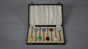 A leather cased set of gilt silver and cloisonné enamel shell design coffee spoons. Hallmarked: