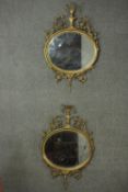 A pair of 19th century gilt wall mirrors with urn and husk cresting and scrolling foliate