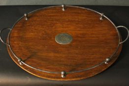 A C.1900 oak tray with silver plated mounts, gallery, handles and bun feet. W.54 L.37cm