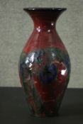 Danico of Denmark art pottery vase, floral Art Nouveau inspired design on ruby ground. Makers mark