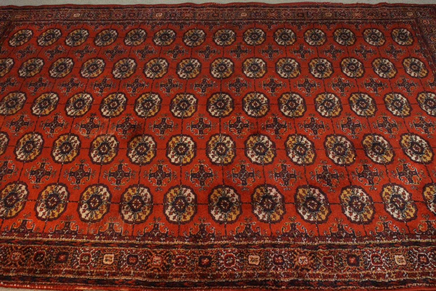 A Bokhara motif carpet with repeating gul medallions on a burgundy ground. L.260 W.190cm. - Image 2 of 4