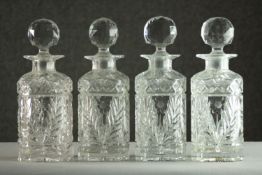 A set of four cut crystal decanters with stoppers. H.25cm.