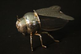 A silver plate and glass novelty bee form honey pot with hinged wing lid and engraved facial