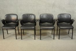 A set of four Herman Miller office armchairs in black leather upholstery.