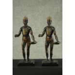 Two early 20th century spelter statues of African kings in tribal clothing, holding a tray with