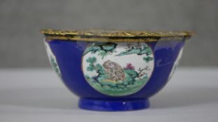 A Chinese hand painted ceramic bowl (used to be a vase) with added gilt ormolu edge. The bowl with a