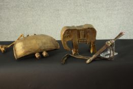 a collection of tribal items, viz: A ceramic elephant, a carved bell and a dagger. H.17 W.22 D.6cm