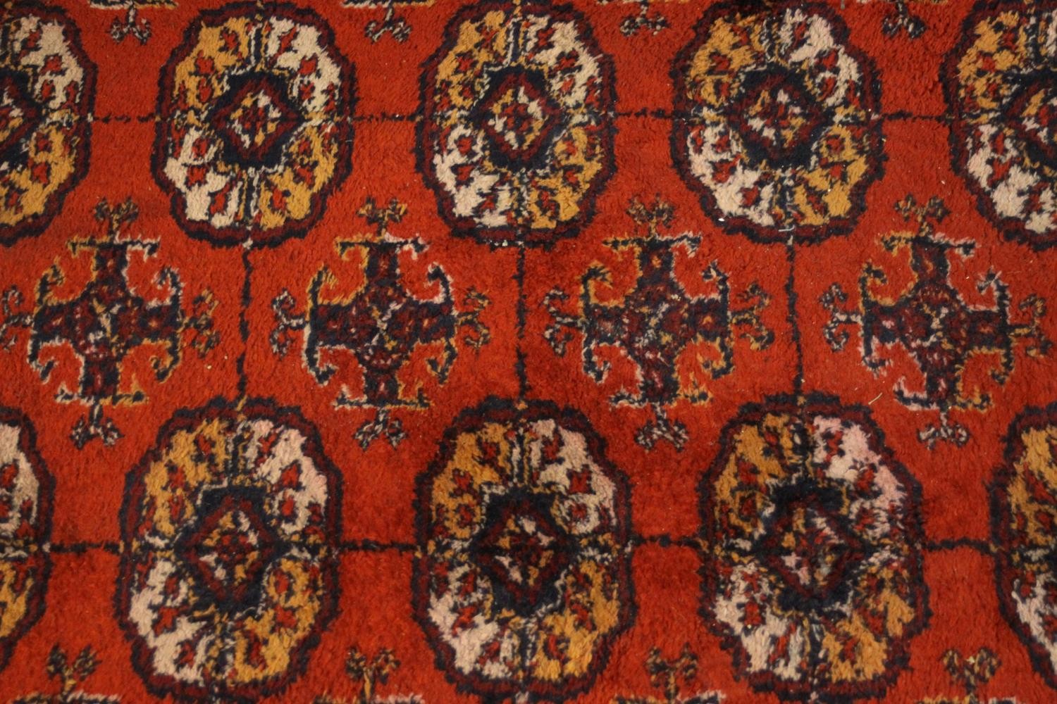 A Bokhara motif carpet with repeating gul medallions on a burgundy ground. L.260 W.190cm. - Image 3 of 4