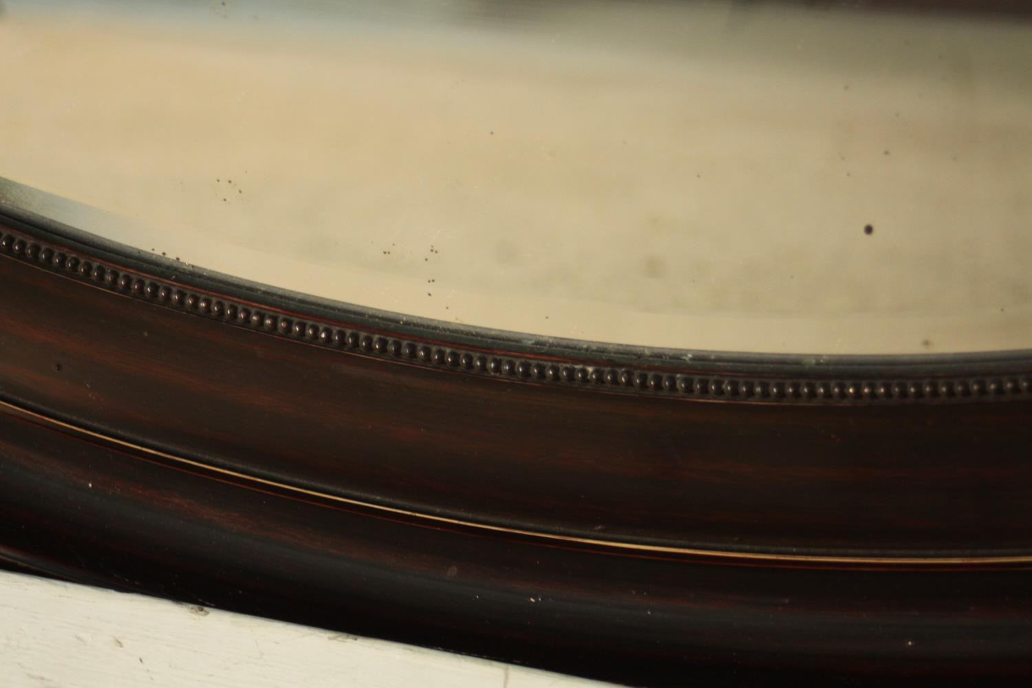A Victorian ebonised framed oval wall mirror with bevelled plate. H.87 W. 61 cm. - Image 3 of 4
