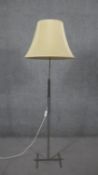 A chrome abstract design standard lamp with cream silk shade. H.162 Diam.56cm
