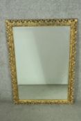 A 20th century pierced gilt foliate design wall mirror with bevelled plate. H.87 W.62cm.