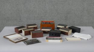A large collection of antique black and white lantern slides of various subjects, some in wooden
