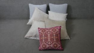 A collection of seven contemporary cushions. Two with a knitted design, and one with makers label.