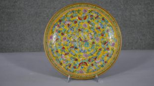 A large Qing period Chinese hand painted famille rose porcelain charger with gold ground and floral,