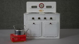 A vintage AMERSHAM TOYS 'Made in England' early 20th century tinplate toy cooker with kettle
