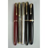 A collection of five 14 carat gold-nibbed vintage Parker fountain pens, including a Parker Duofold