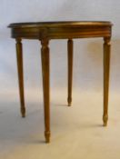 A Louis XVI style gilt occasional table with plate glass on ebonised top with reeded tapering