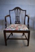 A Georgian mahogany armchair with pierced vase shaped splat on square tapering stretchered supports.