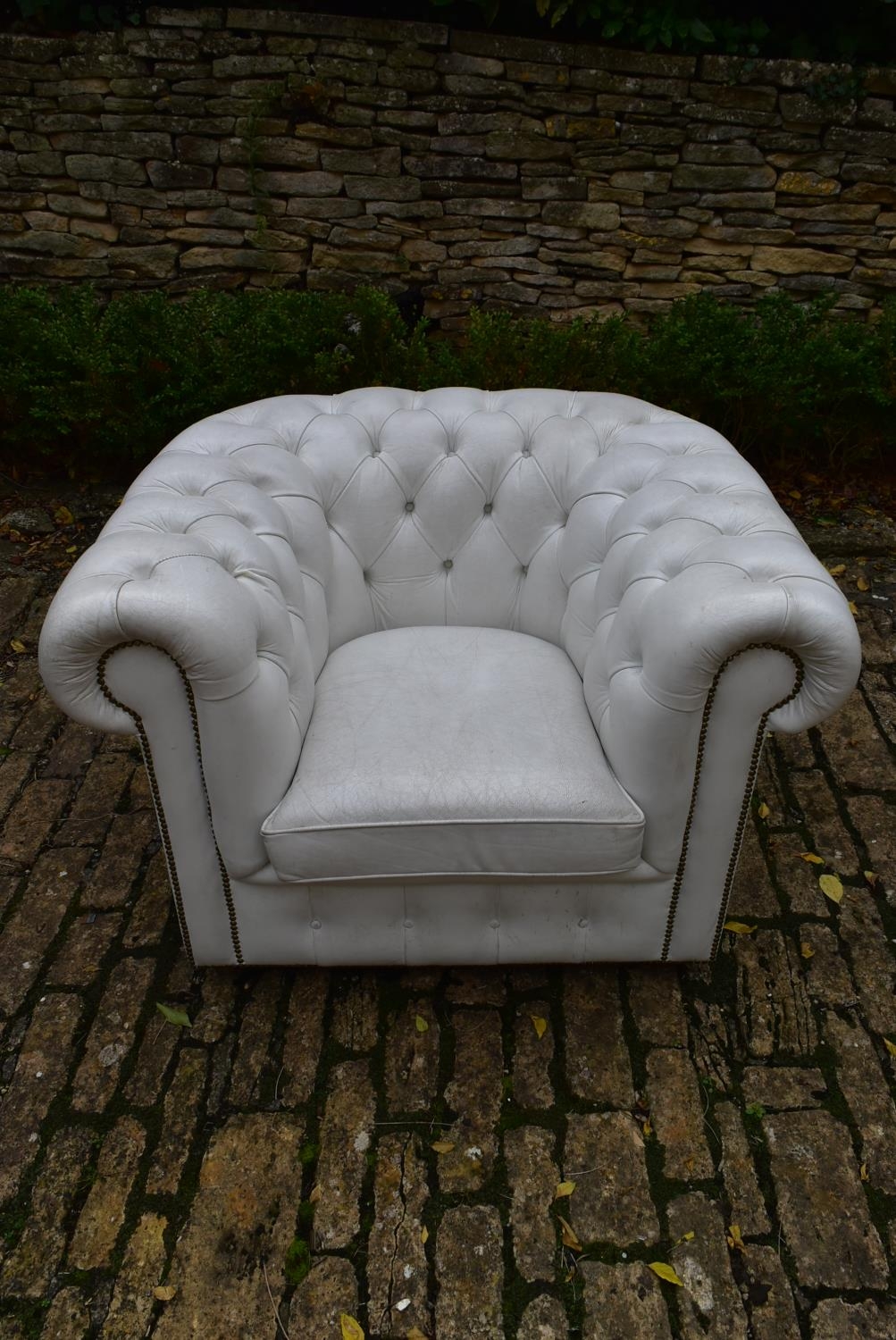 A Chesterfield armchair in deep buttoned and studded leather upholstery. H.70 W.103 D.80cm - Image 2 of 2