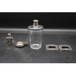 A silver topped dressing table bottle, a Continental silver scent bottle and wine taster along